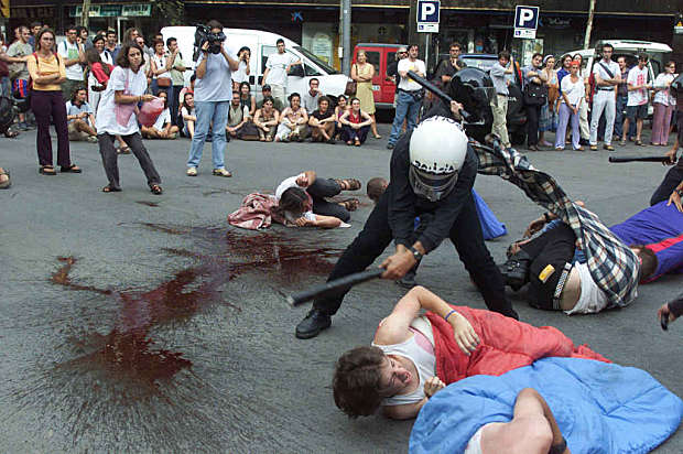 An anti-globalization group of protestors make a performance in front of the Italian embassy in cent..